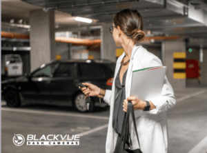 Woman locking car and leaving it in car park protected with BlackVue Dash Camera